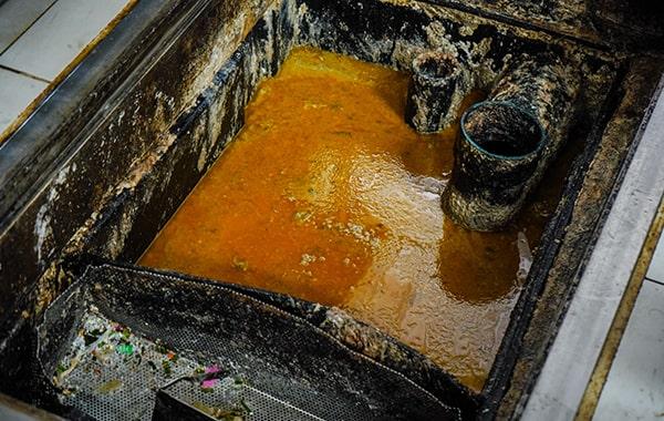 delaying grease trap cleaning can cause clogs, foul odors, and even fines from local authorities